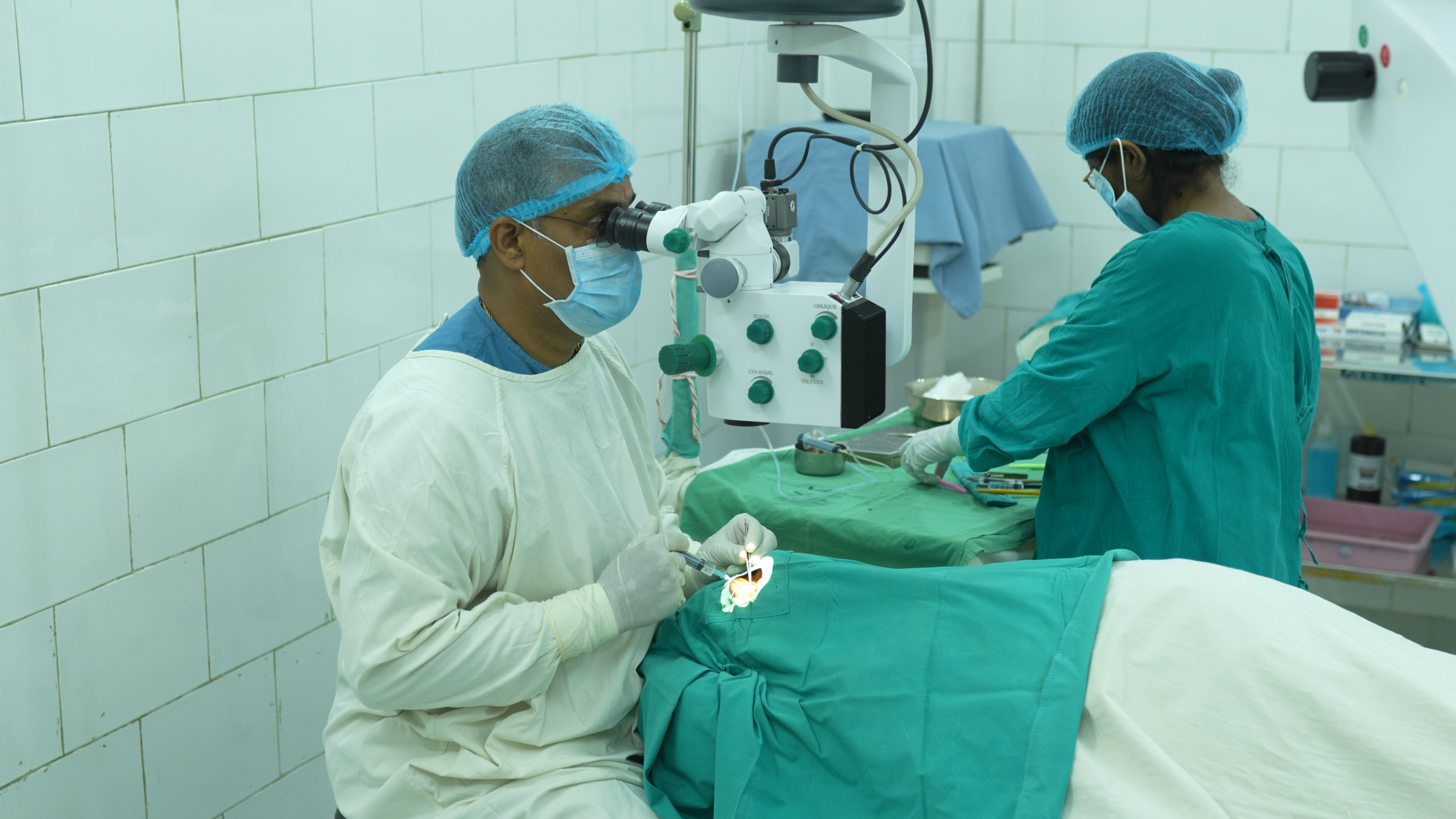 Eye surgery patients and a Hand in Hand staff member together outside in Andhra Pradesh, India, sharing a moment of community and belonging
