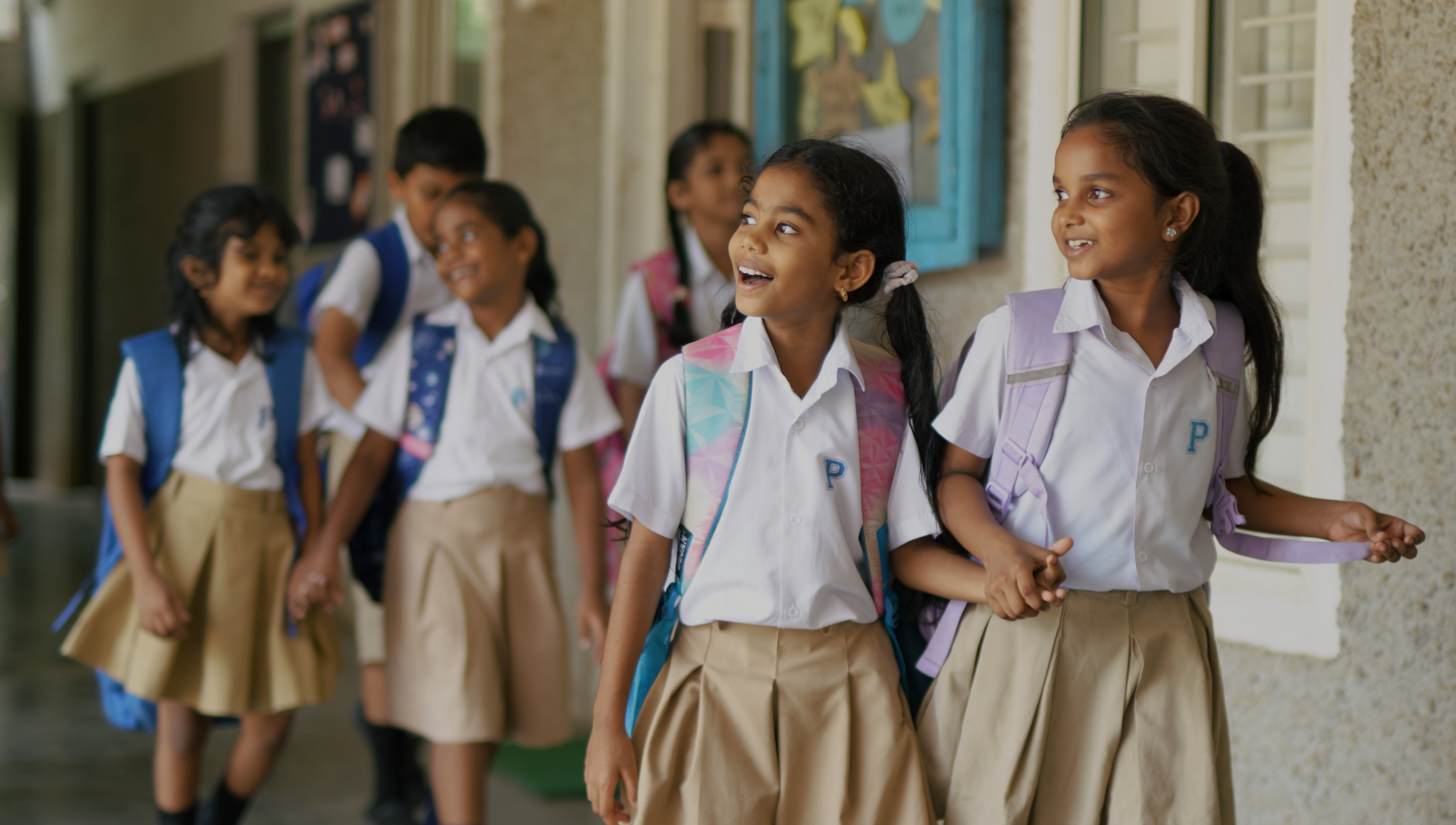 Happy children walking through the corridors of Miriam School